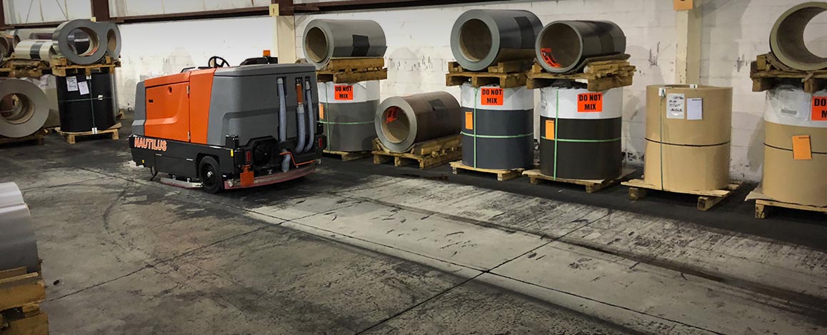 Nautilus machine scrubbing an industrial concrete floor