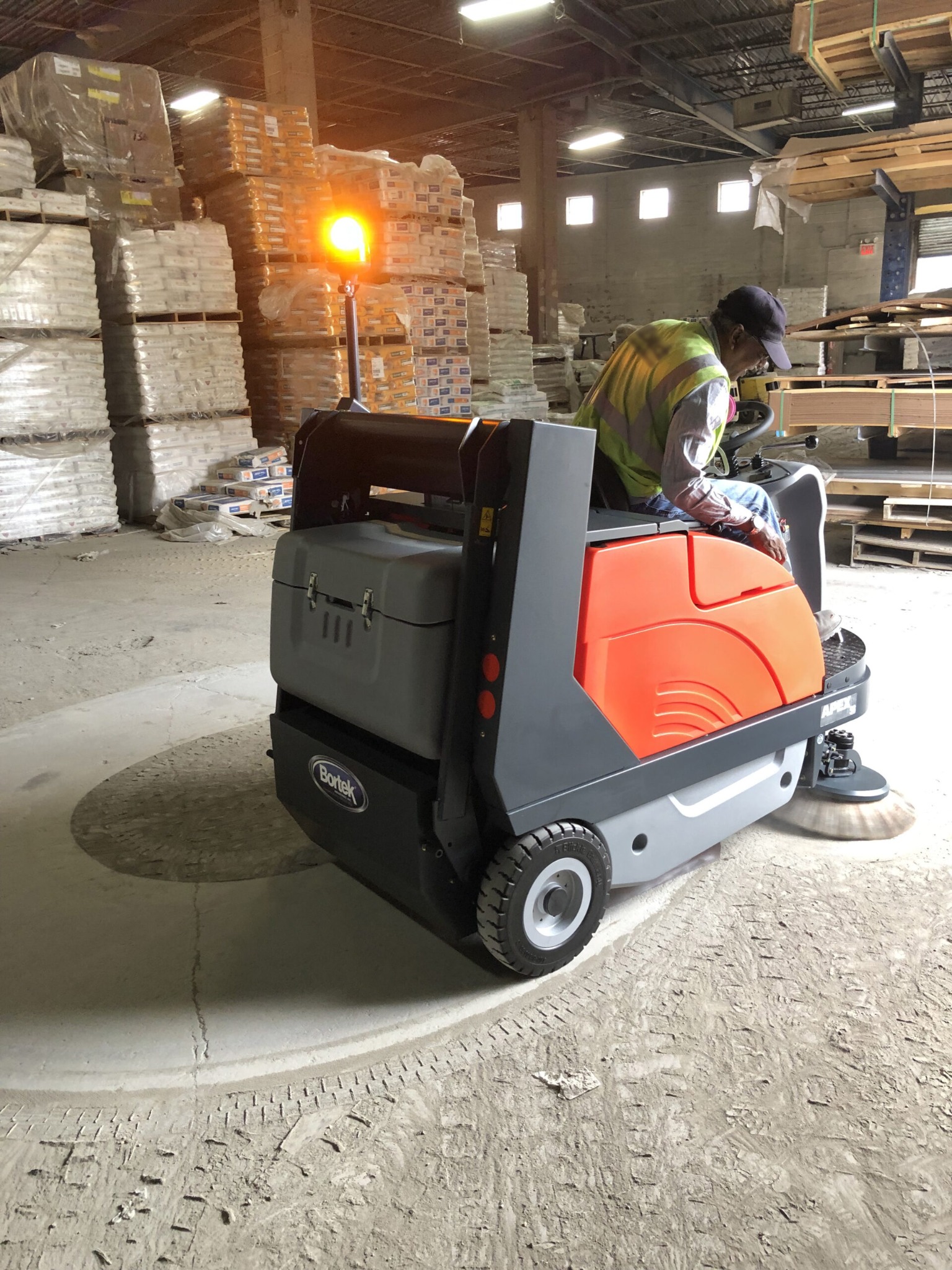 PowerBoss Apex 58 collecting warehouse dust and debris
